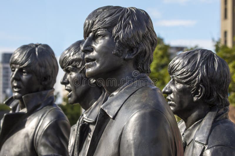 Liverpool, UK - July 30th 2018: Statues of The Beatles - John Lennon, Ringo Starr, George Harrison and Paul McCartney - located on Pier Head in the historic city of Liverpool, UK. Liverpool, UK - July 30th 2018: Statues of The Beatles - John Lennon, Ringo Starr, George Harrison and Paul McCartney - located on Pier Head in the historic city of Liverpool, UK.