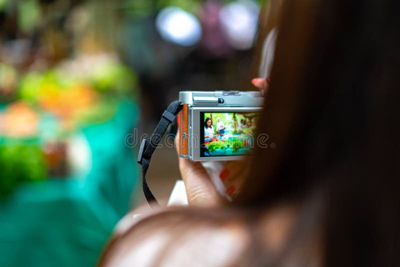 Die Frau hält die Weinlesekamera und macht ein Foto des lokalen Gemüsemarktes lizenzfreies stockfoto Die Frau hält die Weinlesekamera und macht ein Foto des lokalen Gemüsemarktes lizenzfreies stockfoto