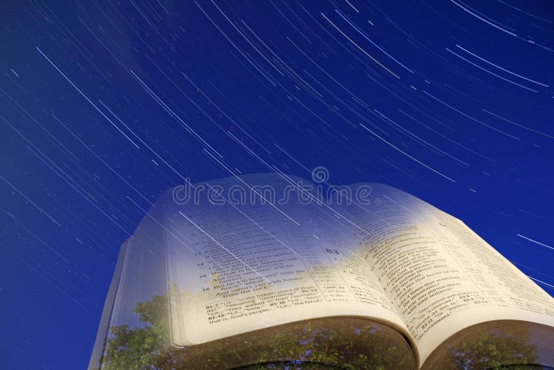 Concept photo of god`s creative works depicted by open holy bible set against heavenly star trails. Concept photo of god`s creative works depicted by open holy bible set against heavenly star trails.