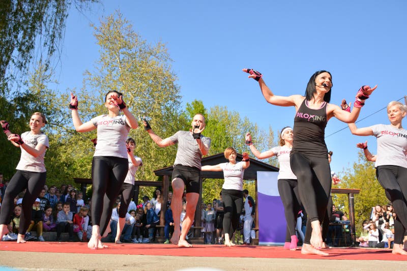 Nis, Serbia - April 20, 2019: Join a vibrant group of young individuals as they gather on a sunny spring day for an invigorating outdoor Piloxing session. Led by a dynamic teacher in a stylish black t-shirt, armed with a microphone, this engaging class combines the elements of boxing, pilates, and dancing to bring you a unique and empowering fitness experience. The open stage provides the perfect setting for this high-energy workout, allowing you to soak up the sunshine and enjoy the refreshing outdoor atmosphere. As you join the enthusiastic group, you'll feel the energy and excitement in the air, creating a supportive and motivating environment for your fitness journey. Under the guidance of the experienced teacher, you'll dive into the world of Piloxing, a fusion of cardio, strength training, and flexibility exercises. Prepare to sweat, move, and unleash your inner strength as you incorporate powerful boxing moves, precise pilates techniques, and expressive dance elements into your workout routine. The teacher, equipped with a microphone, ensures clear and effective communication, guiding you through each exercise with enthusiasm and expertise. Whether you're a beginner or a fitness enthusiast, modifications and progressions will be provided, allowing you to tailor the intensity of the workout to your own fitness level. Engage your entire body as you punch, kick, and perform fluid movements that challenge your cardiovascular endurance and build lean muscle. Focus on your core stability and alignment during the pilates-inspired exercises, improving your posture and enhancing your overall body strength. As you embrace the rhythmic and expressive dance elements, let yourself be carried away by the music and feel the joy of movement. Unleash your creativity and connect with your body in a way that uplifts both your physical and mental well-being. This outdoor Piloxing training session is not just about working up a sweat, but also about building a sense of community and support. Encourage and inspire one another as you share this fitness journey, celebrating each milestone and cheering on the progress of your fellow participants. Don't miss the chance to be a part of this exhilarating Piloxing experience. Grab your workout gear, bring your positive energy, and head to the open stage where the teacher in the black t-shirt awaits. Get ready to sweat, move, and unleash your inner strength as you participate in this outdoor Piloxing training session. Nis, Serbia - April 20, 2019: Join a vibrant group of young individuals as they gather on a sunny spring day for an invigorating outdoor Piloxing session. Led by a dynamic teacher in a stylish black t-shirt, armed with a microphone, this engaging class combines the elements of boxing, pilates, and dancing to bring you a unique and empowering fitness experience. The open stage provides the perfect setting for this high-energy workout, allowing you to soak up the sunshine and enjoy the refreshing outdoor atmosphere. As you join the enthusiastic group, you'll feel the energy and excitement in the air, creating a supportive and motivating environment for your fitness journey. Under the guidance of the experienced teacher, you'll dive into the world of Piloxing, a fusion of cardio, strength training, and flexibility exercises. Prepare to sweat, move, and unleash your inner strength as you incorporate powerful boxing moves, precise pilates techniques, and expressive dance elements into your workout routine. The teacher, equipped with a microphone, ensures clear and effective communication, guiding you through each exercise with enthusiasm and expertise. Whether you're a beginner or a fitness enthusiast, modifications and progressions will be provided, allowing you to tailor the intensity of the workout to your own fitness level. Engage your entire body as you punch, kick, and perform fluid movements that challenge your cardiovascular endurance and build lean muscle. Focus on your core stability and alignment during the pilates-inspired exercises, improving your posture and enhancing your overall body strength. As you embrace the rhythmic and expressive dance elements, let yourself be carried away by the music and feel the joy of movement. Unleash your creativity and connect with your body in a way that uplifts both your physical and mental well-being. This outdoor Piloxing training session is not just about working up a sweat, but also about building a sense of community and support. Encourage and inspire one another as you share this fitness journey, celebrating each milestone and cheering on the progress of your fellow participants. Don't miss the chance to be a part of this exhilarating Piloxing experience. Grab your workout gear, bring your positive energy, and head to the open stage where the teacher in the black t-shirt awaits. Get ready to sweat, move, and unleash your inner strength as you participate in this outdoor Piloxing training session.