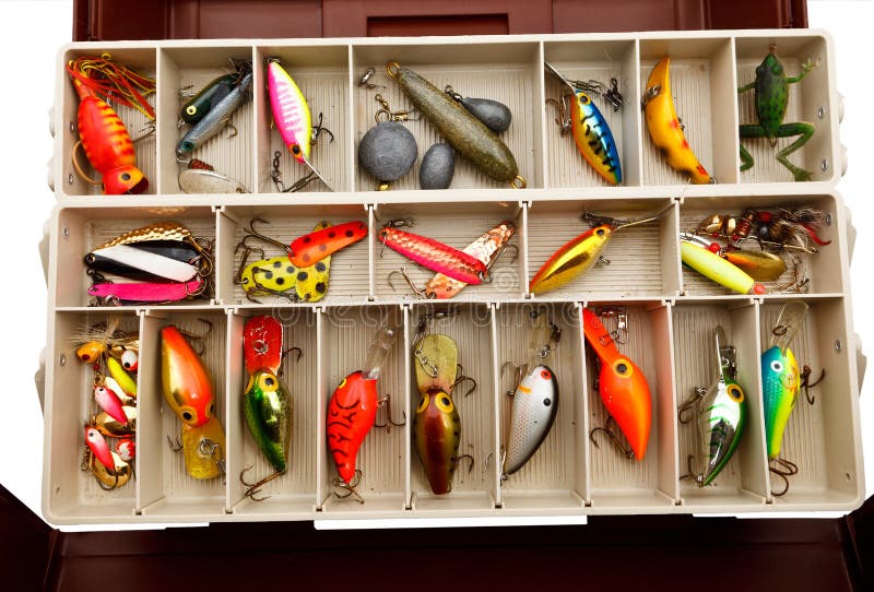 Colorful fishing lures in compartments in an old tackle box. Colorful fishing lures in compartments in an old tackle box.