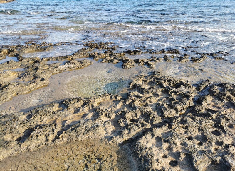 Die Küste des Mittelmeers lange gefrorene Lava in den Nischen, in denen Wasser spritzt stockbild