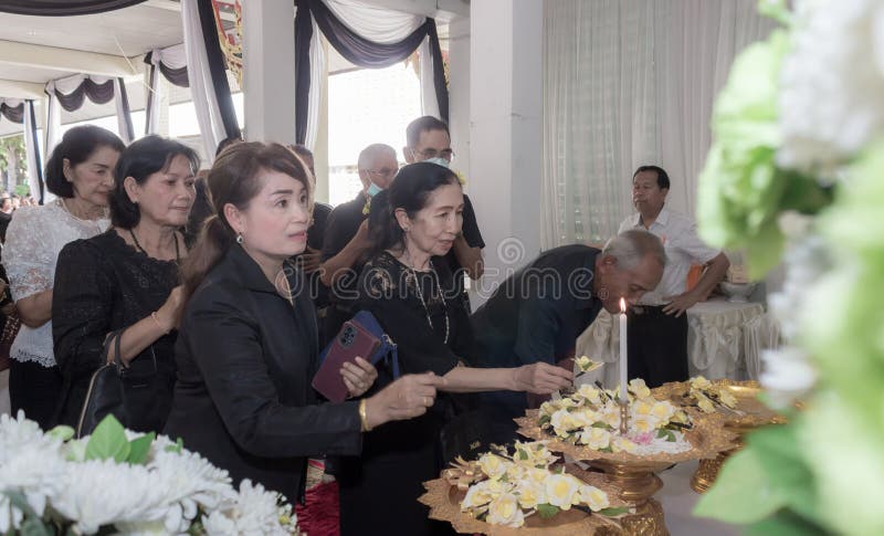 Phatthalung, Thailand- April 05, 2024: People wore black clothes and laid flowers to pay their respects at the cremation ceremony. Phatthalung, Thailand- April 05, 2024: People wore black clothes and laid flowers to pay their respects at the cremation ceremony