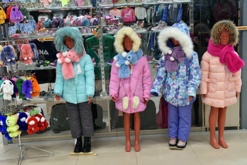 Die Mannequins der Kinder des Winters in den Jacken unten im Speicher stockfoto Die Mannequins der Kinder des Winters in den Jacken unten im Speicher stockfoto