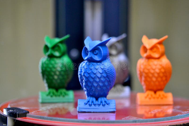 The models of owls created on the 3d printer stand on the desktop of 3d printer close-up. Progressive modern additive technologies 4.0 industrial revolution. The models of owls created on the 3d printer stand on the desktop of 3d printer close-up. Progressive modern additive technologies 4.0 industrial revolution