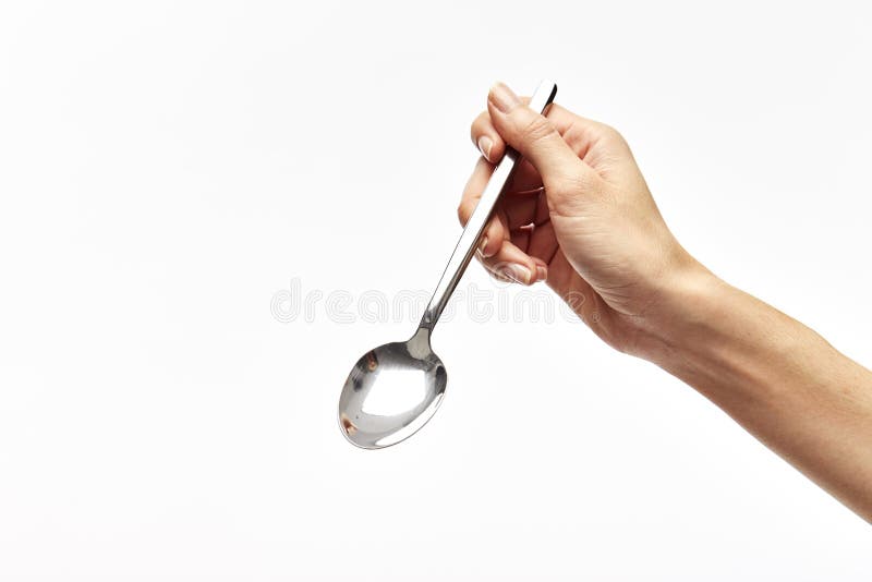 die rechte Hand der Frau hält einen Löffel lizenzfreies stockbild die rechte Hand der Frau hält einen Löffel lizenzfreies stockbild