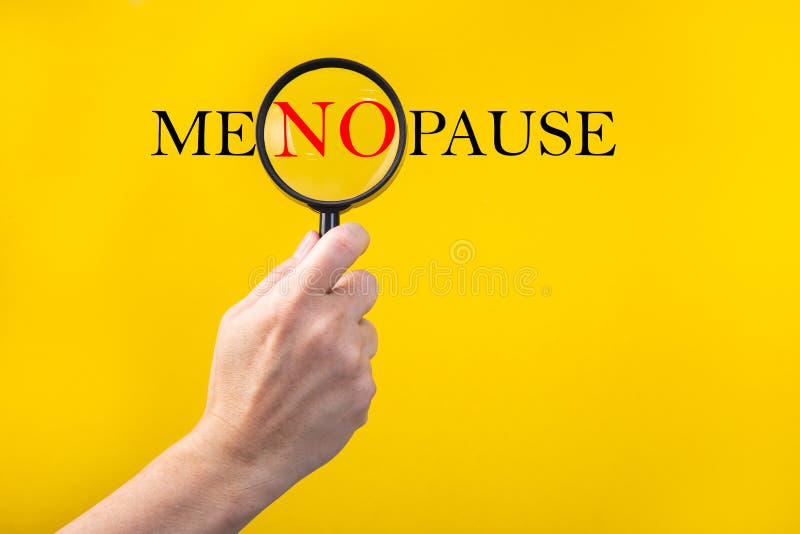 The word Menopause through a magnifying glass on a yellow background. The word Menopause through a magnifying glass on a yellow background