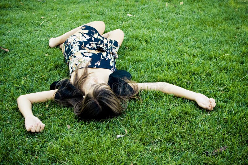 Died or resting woman in the grass