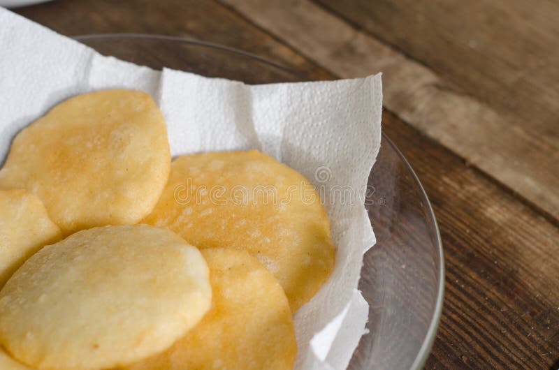 Tray of freshly fried arepas, typical Latin American food made with cornmeal. Tray of freshly fried arepas, typical Latin American food made with cornmeal.