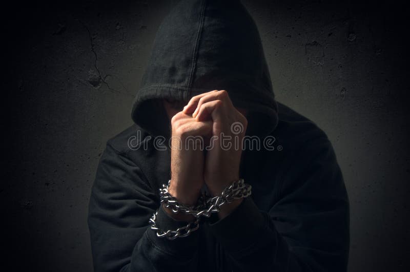 Male hands with chain wrapped around them, prisoner concept. Male hands with chain wrapped around them, prisoner concept