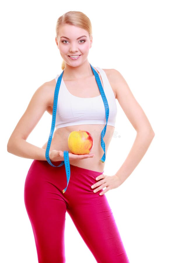 Diet. Fitness woman fit girl with measure tape and apple fruit