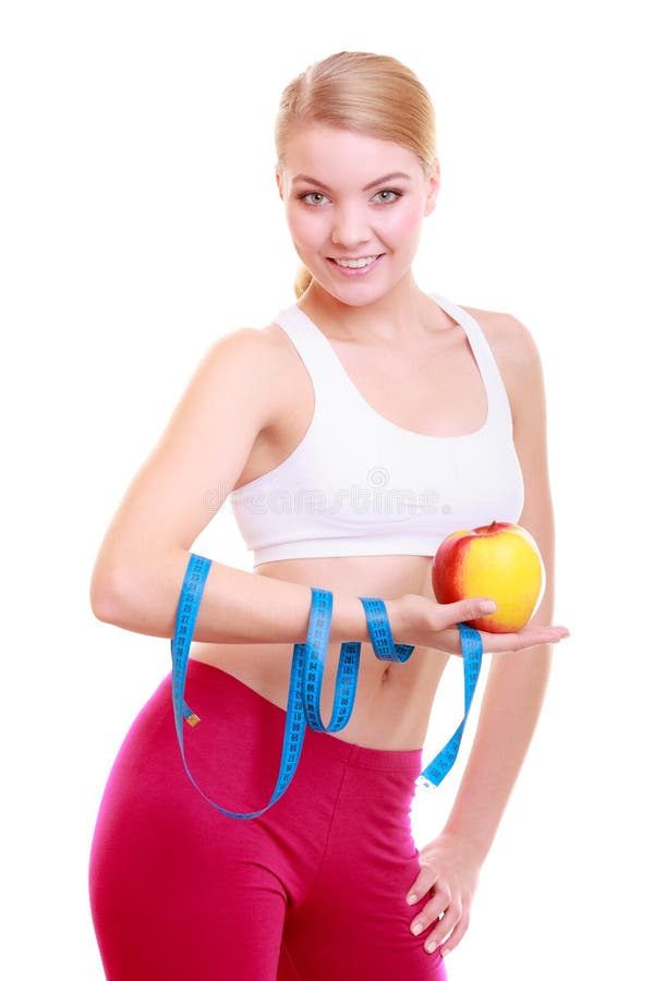 Diet. Fitness woman fit girl with measure tape and apple fruit