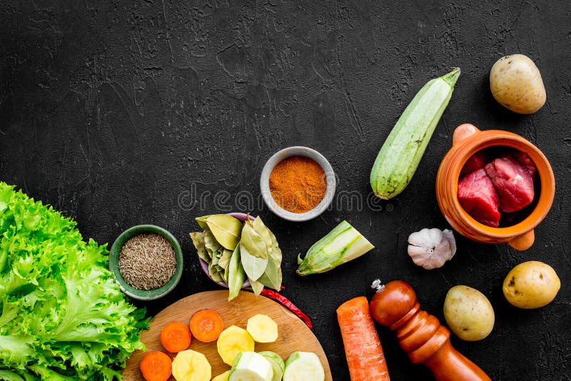 Diet vegetarian vegan food. Ratatouille or vegetable ragout. Black table background top view space for text royalty free stock images Diet vegetarian vegan food. Ratatouille or vegetable ragout. Black table background top view space for text royalty free stock images