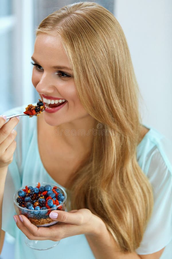 Dieta sana Mujer que come el cereal, bayas por mañana Nutrición imagenes de archivo Dieta sana Mujer que come el cereal, bayas por mañana Nutrición imagenes de archivo