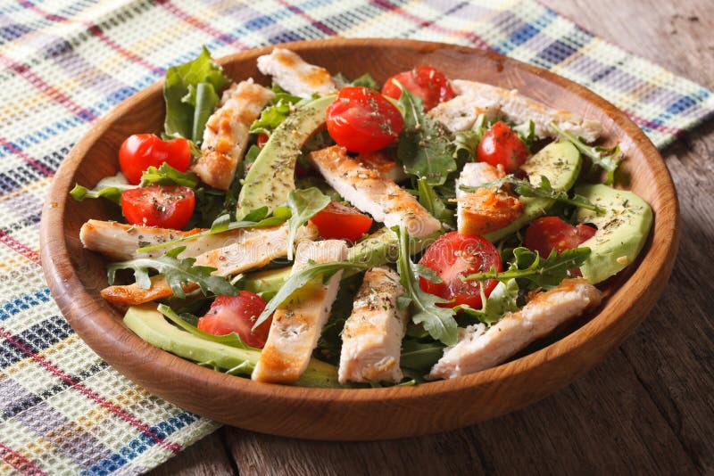 Dietary chicken salad with avocado, arugula and cherry tomatoes
