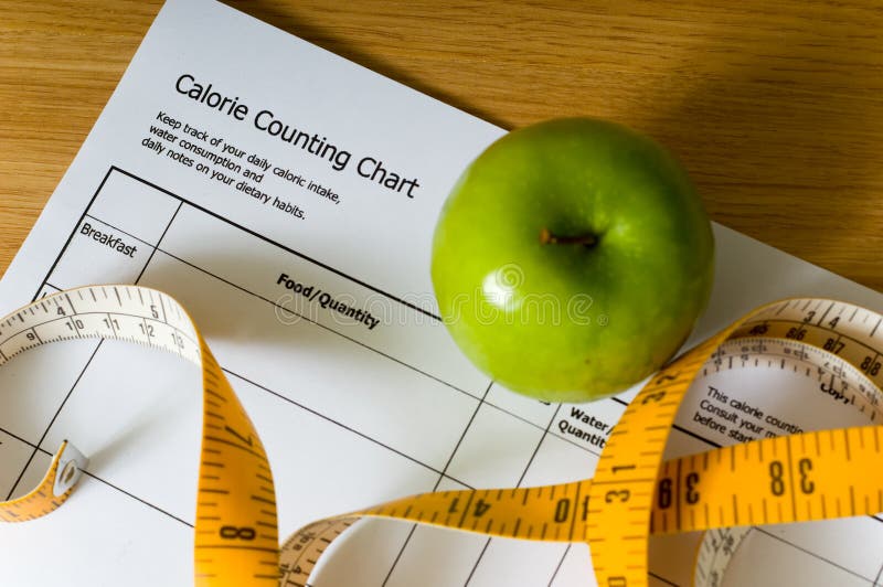 Calorie counting chart, green apple and tape measure, items for a diet. Calorie counting chart, green apple and tape measure, items for a diet