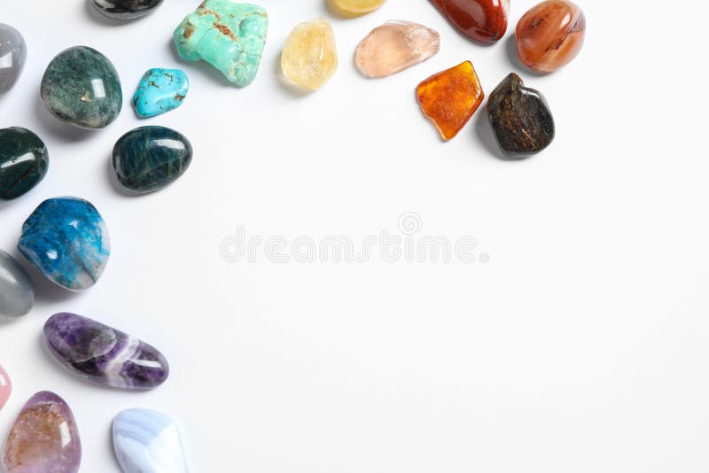 Different beautiful gemstones on white, top view stock photo