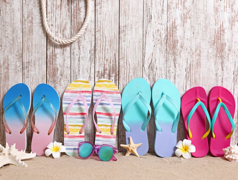 Different Bright Flip Flops and on Sand Near Wooden Wall, Space for ...