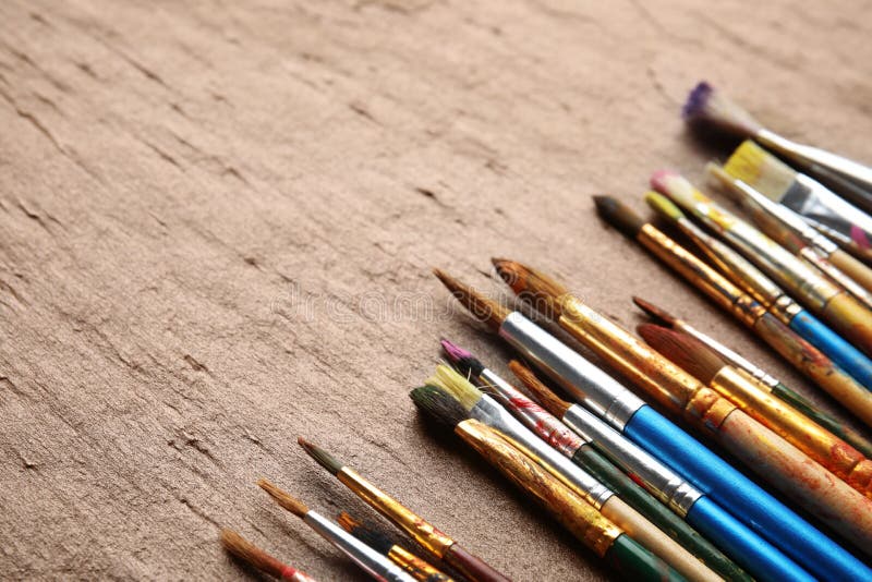 Different Bright Paint Brushes on Color Table. Stock Photo Image of