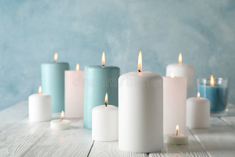 Different burning candles against background, space for text stock photo