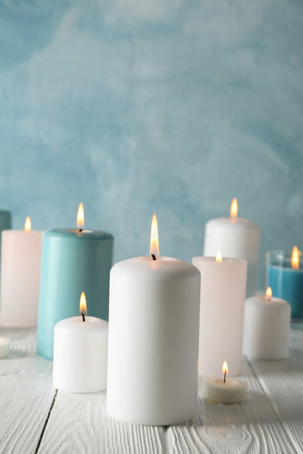 Different burning candles against background, space for text stock photo