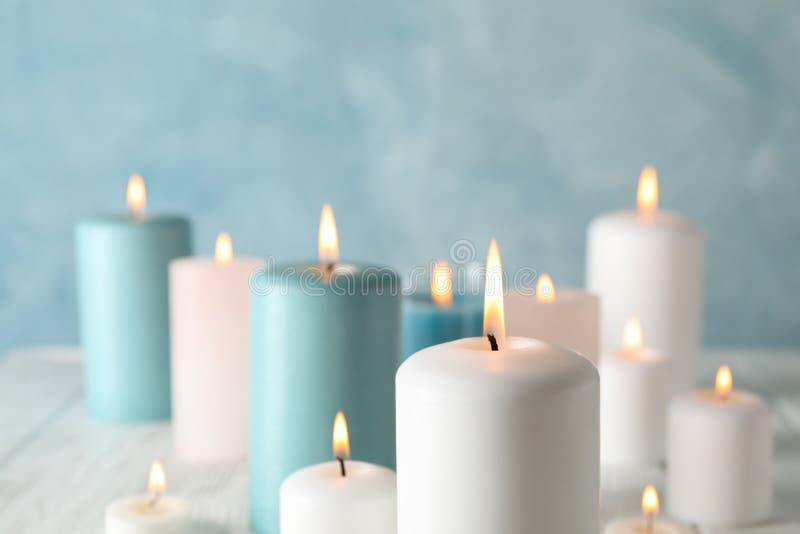Different burning candles against background, space for text stock images