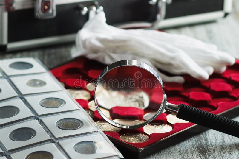 Magnifying glass and coins at the background, Stock image