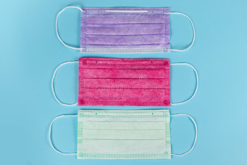 Different Colored Medical Masks on Blue Background Stock Photo Image