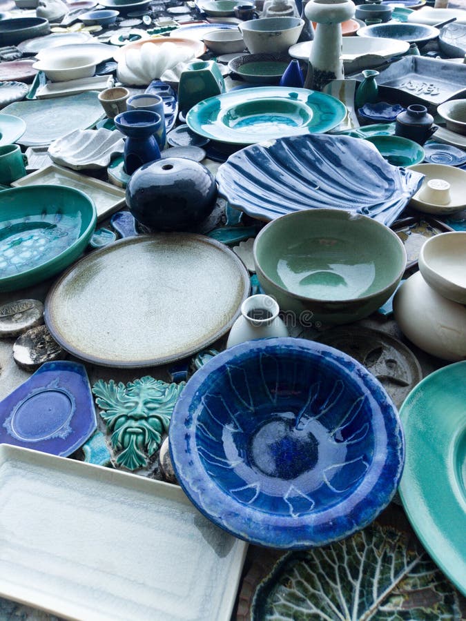 Different Colorful Ceramic Plates on the Orange Wall Stock Image