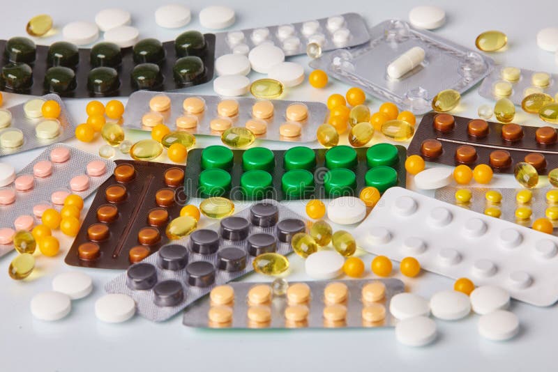 Different colorful packs of pills and tablets on white background. stock image Different colorful packs of pills and tablets on white background. stock image