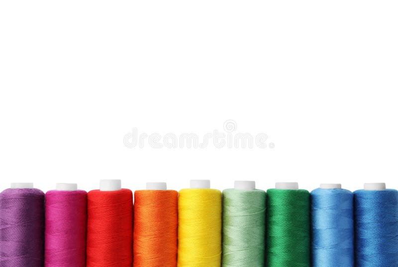 Different colorful sewing threads on white background, top view
