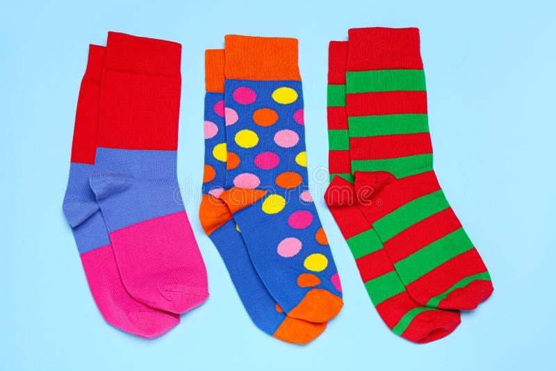Different Colorful Socks on Light Blue Background, Flat Lay Stock Photo