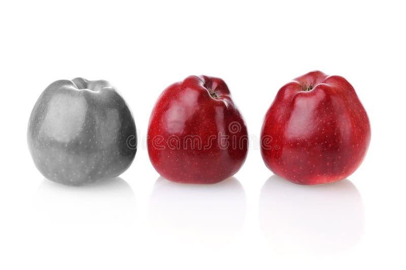 Different colourless apple with two red ones royalty free stock images