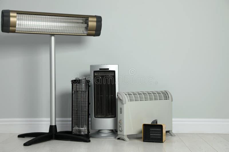 Different Electric Heaters Near Light Grey Wall Indoors. Space for Text Stock Image Image of