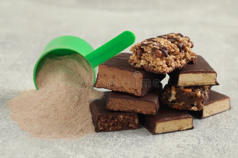 Different Energy Bars and Protein Powder on Grey Table, Closeup Stock