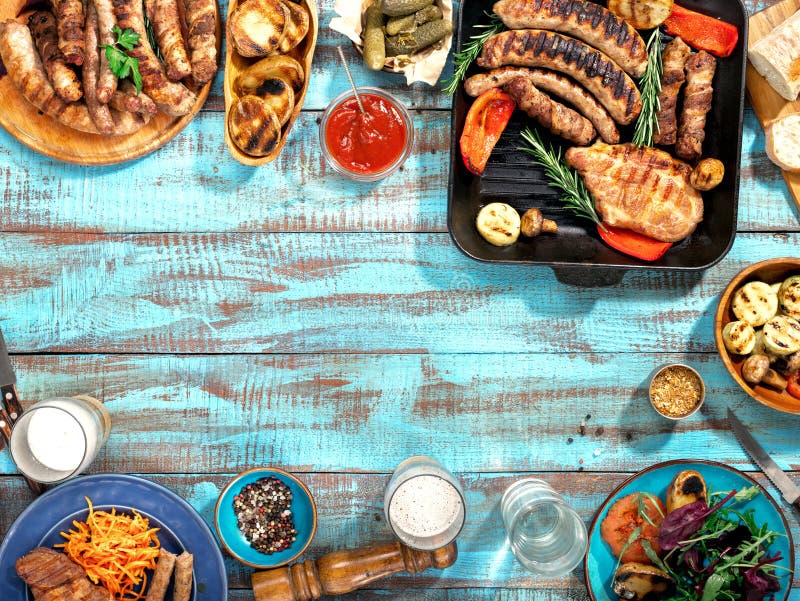 Different food cooked on the grill on blue wooden table royalty free stock photos Different food cooked on the grill on blue wooden table royalty free stock photos
