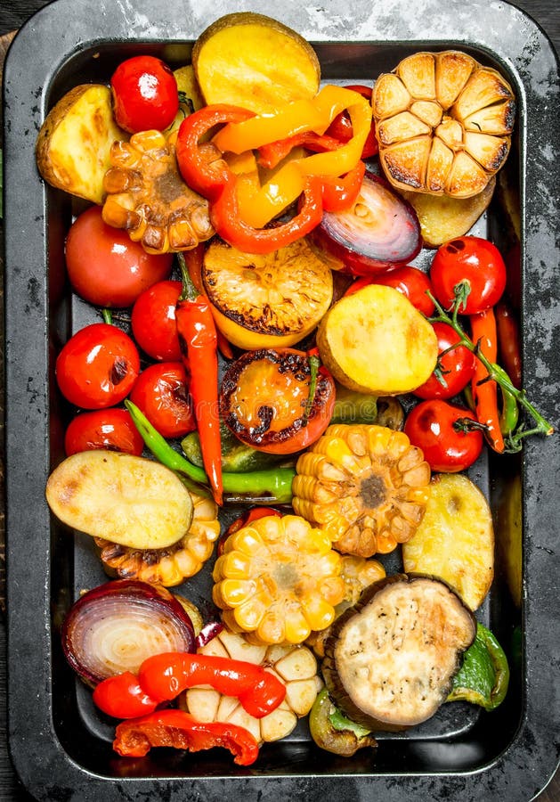 Grilled Vegetables with Spices and Herbs on a Cutting Board Stock Photo