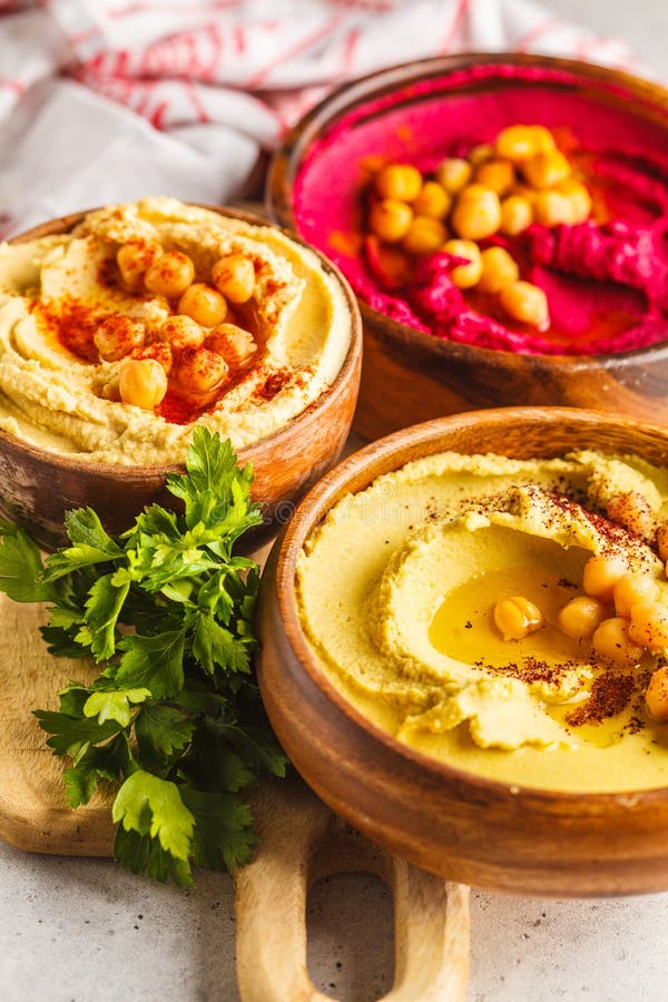 Different Hummus Bowls. Chickpea Hummus, Avocado Hummus and Beet Stock