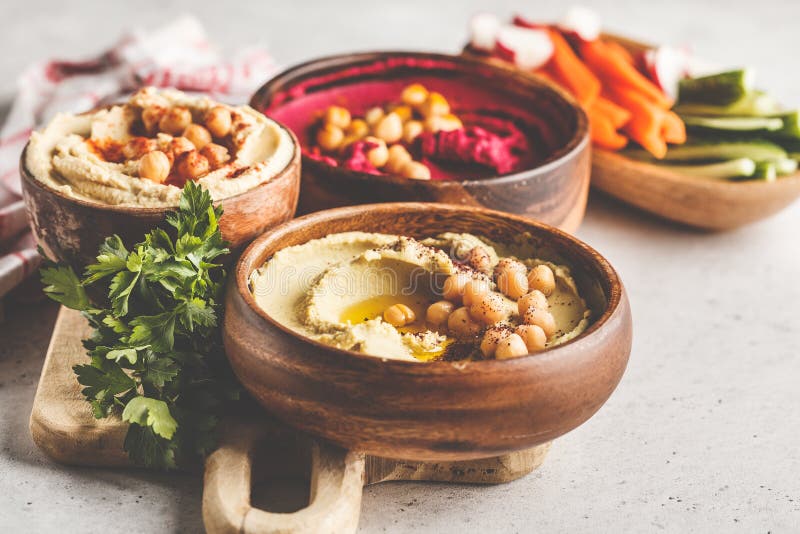 Different Hummus Bowls. Chickpea Hummus, Avocado Hummus and Beet Stock