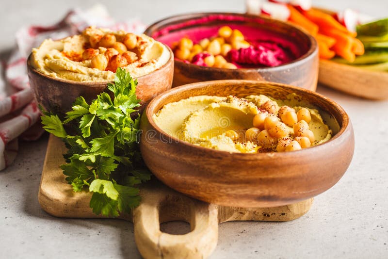 Different Hummus Bowls. Chickpea Hummus, Avocado Hummus and Beet Stock