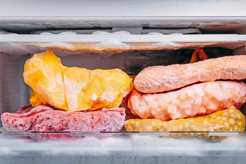 Different kind of deep frozen vegetables in plastic bags in a refrigerator