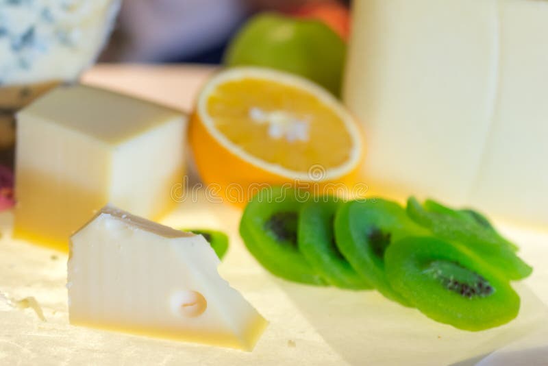 Different kinds of cheese with fresh fruits on table royalty free stock image