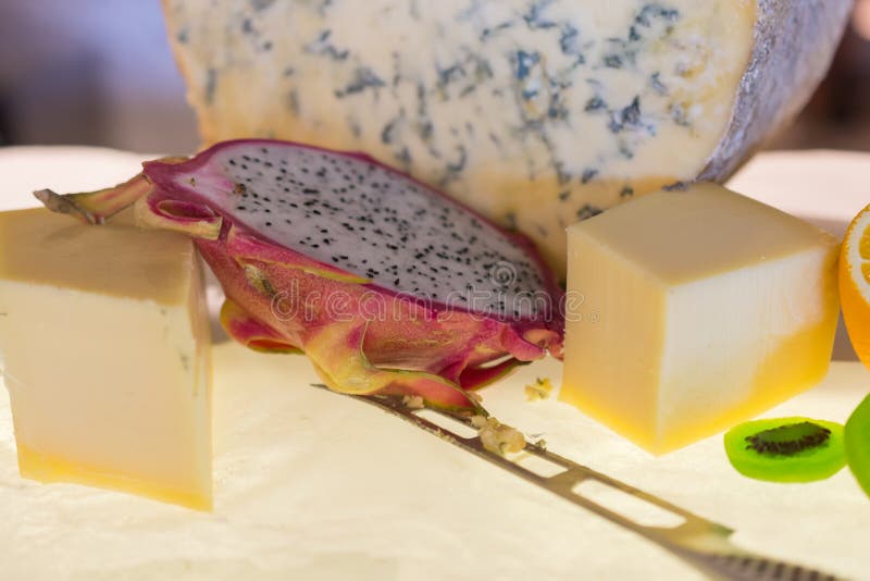 Different kinds of cheese with fresh fruits on table royalty free stock photos