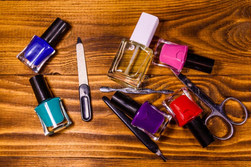 Different Manicure Tools and Nail Polishes on Wooden Table. Top View