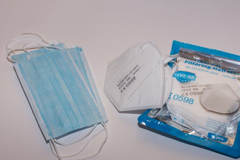 Different Masks and White FFP2 or KN95 Mask on Light Gray Stock Photo