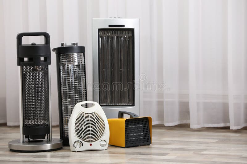 Different Modern Electric Heaters on Floor in Room Stock Image Image