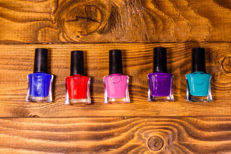 Different Nail Polishes on a Wooden Table. Top View Stock Photo Image