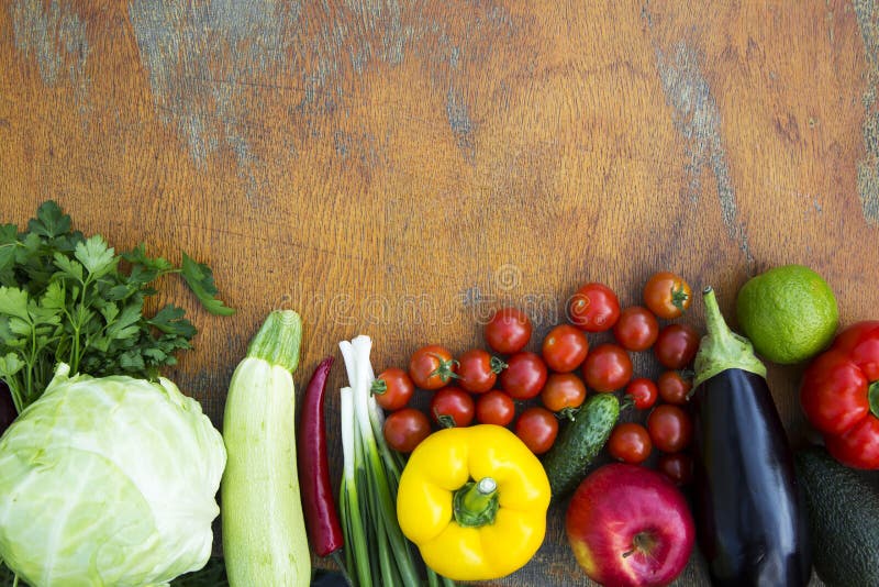 Different organic fruits and vegetables on wooden table. Copy sp