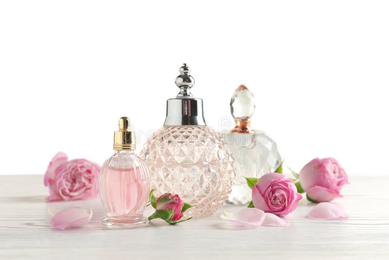 Different perfume bottles and flowers