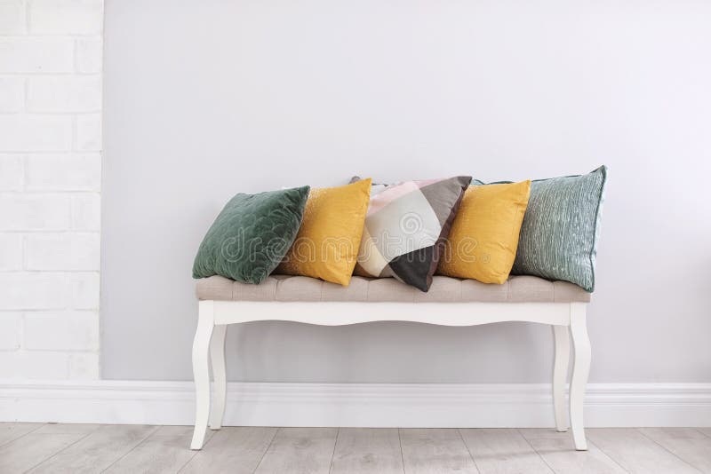 Different Pillows on Couch Near Light Wall Stock Photo Image of